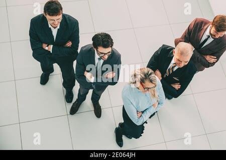 top view. confident business woman standing in front of her colleagues. Stock Photo