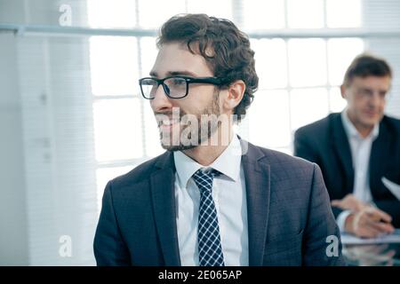 attractive business man standing in the office. Stock Photo