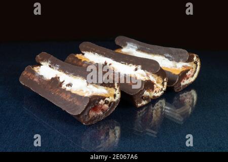 The Sweet meat loaf in chocolate on table with reflection. Products of the feeding on black background Stock Photo