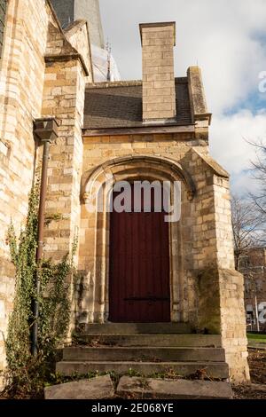 the back door with old broken stairs and wall of a church building Stock Photo