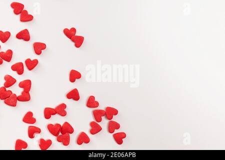 Sugar heart shaped sprinkles on white background Stock Photo