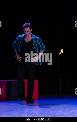 Actor dancer young man performs in the theater on stage in a dance musical show Stock Photo