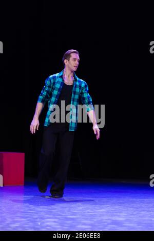 Actor dancer young man performs in the theater on stage in a dance musical show Stock Photo