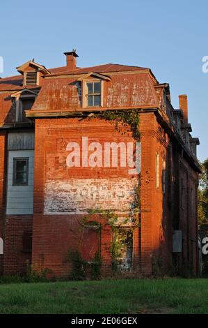 A ghost sign adorns the brick wall of the former Bourbon Hotel. Now abandoned, the building used to serve railway and Route 66 travelers. Stock Photo