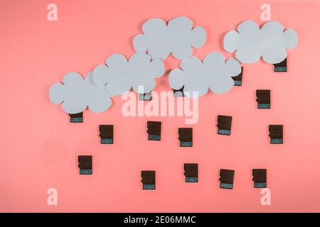 Cloud computing concept, paper clouds with micro SD cards as raindrops Stock Photo