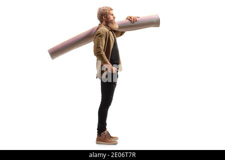 Bearded man standing a holding a carpet in a roll on his shoulder isolated on white background Stock Photo