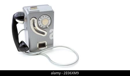 Old telephone set from the 60's for use with coins isolated on a white background. Space for text. Communication concept. Stock Photo