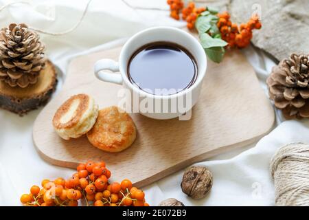 Cup of coffee and pancakes with autumn dry leaves Stock Photo