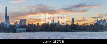 Panorama of Central Park Reservoir, with reservoir in foreground and background with skyscrapers and sunset Stock Photo