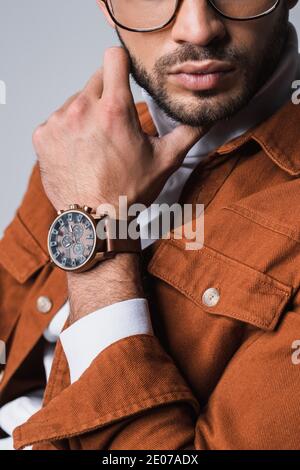 Cropped view of stylish man in terracotta jacket and wristwatch isolated on grey Stock Photo