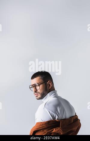Stylish man in white turtleneck and jacket looking away isolated on grey Stock Photo