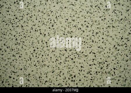 light texture with patches of black particles. Imitation of light granite texture. Stock Photo