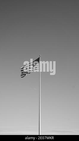 Flag of the United States, aka American flag or the U.S. flag- the national flag of America blowing in the wind. Black and white photo. Stock Photo