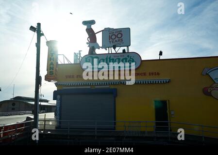 Nathan's Famous Hot Dogs Restaurant, Coney Island, New York. Sun Shining, Store Closed, Blue Sky, Shutters Down. Stock Photo