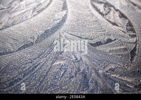Abstract winter pattern of ice on glass. Winter ice patterns on window. Stock Photo