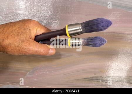 Brushes for painting  lying on an old canvas painted with oil paints Stock Photo