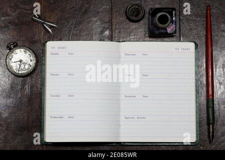 opened blank diary with dib pen and inkwell on desktop Stock Photo