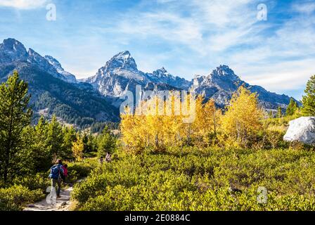 A young family hiking to Taggart  lake, Tetons National Park, Wyoming, USA. Stock Photo