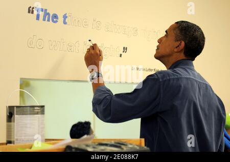 US president Barck Obama paints Martin Luther King Jr's famous phrase ' I have a dream ' as she joins volunteers in a library, participating in a service project, at Browne Education Centerin Washington DC, USA on January 16, 2012, on the Martin Luther King Jr national holiday. The project was in memory of the legacy of community service, promoted by the late civil rights leader, who was assassinated in 1968. Photo by Mike Theiler/Pool/ABACAPRESS.COM Stock Photo