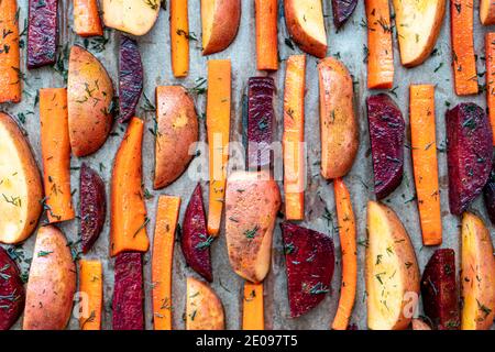 restaurant, vegetarianism, fast, health, recipes concepts - Oven baked cut vegetables potatoes carrots, mushrooms with seasoning dill. Roasted Stock Photo