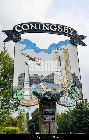 Coningsby village sign, associated with RAF Coningsby and depicting planes from the Royal Air Force Battle of Britain Memorial Flight, church Stock Photo