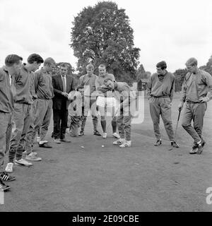 File photo dated 29/07/66 of Jimmy Greaves (third right) lining up a putt as he and his teammates take a break from preparing for the World Cup Final at Roehampton Sports Ground. Looking on are (left to right) trainer Les Cocker, Peter Bonetti, Bobby Moore, unknown, Jimmy Armfield, Roger Hunt, Ron Springett, Norman Hunter and Ron Flowers. The two last remaining members of the 1966 World Cup winning squad, Ron Flowers and Jimmy Greaves have both been awarded MBE for services to Football in the New Year's Honours List. Stock Photo