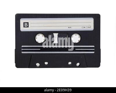 An unmarked, black analog cassette tape is shown on its B side, in a closeup view and isolated against a white background. Stock Photo