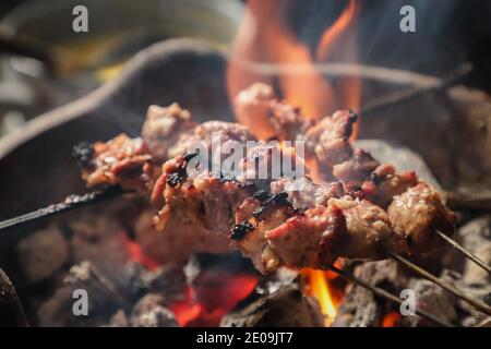 Sate Klatak, the Javanese Lamb Satay with Bicycle Spoke Skewer, Being Grilled on Charcoal Fire Stock Photo