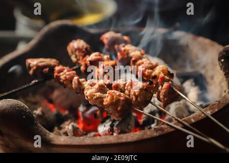 Sate Klatak, the Javanese Lamb Satay with Bicycle Spoke Skewer, Being Grilled on Charcoal Fire Stock Photo