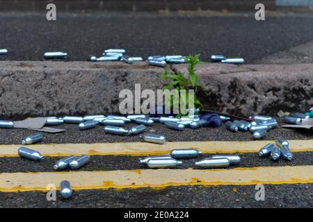 Discarded Nitrous Oxide canisters, also known as Laughing Gas on a street in Leicester Stock Photo