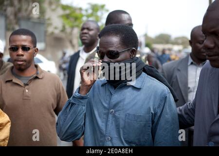 Opposition activist and Senegalese presidential candidate Ibrahima Fall joins protesters during a demonstration march called by opposition activists of the M23 movement opposed to Senegal President Abdoulaye Wade's campaign for a controversial third term in office, in Dakar, on February 15, 2012, ahead of the February 26 national elections. Scores of police pushed back groups of opposition protesters who attempted to converge in the suburb of Medina, later firing tear gas as they tried to begin the march to Independence Square in the heart of the city led by presidential candidate Ibrahima Fal Stock Photo