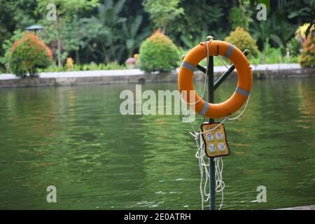 Safety equipment. Bright red safe lifebuoy on the pier Stock Photo