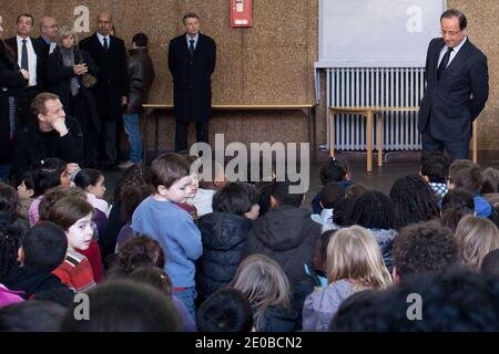 France's opposition Socialist Party (PS) candidate for the 2012 presidential election Francois Hollande observes a minute of silence with pupils at the Jean Jaures school on March 20, 2012 in Le Pre-Saint-Gervais, one day after the shooting of the 'Ozar Hatorah' Jewish school in the southwestern city of Toulouse, where four people (three of them children), were killed and two seriously wounded when a gunman opened fire yesterday. This is the third gun attack in a week by a man who fled on a motorbike. Photo by Stephane Lemouton/ABACAPRESS.COM. Stock Photo
