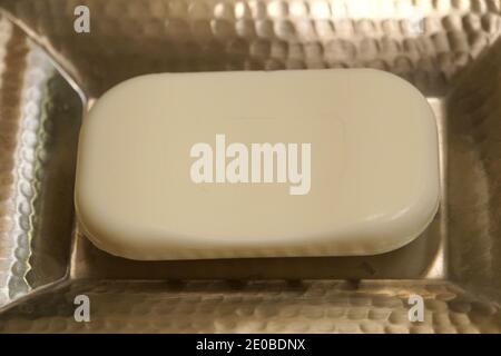 Close up of a white soap on a silver holder Stock Photo