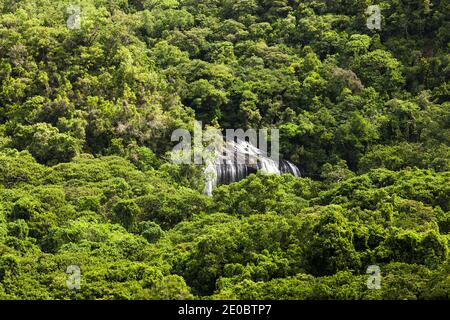Distant view of Ngardmau Waterfall and deep jngule of rain forest mountain, Ngardmau, Island of Babeldaob, Palau, Micronesia, Oceania