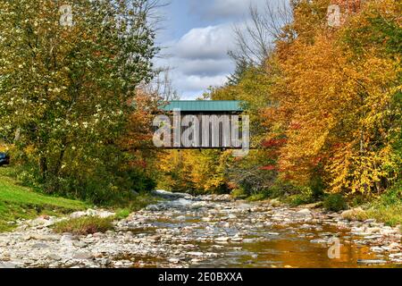 Grist Mill Covered Bridge in Cambridge, Vermont during fall foliage. Stock Photo