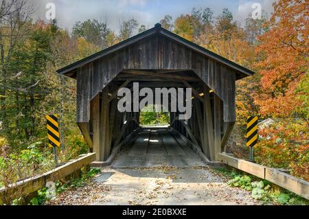 Grist Mill Covered Bridge in Cambridge, Vermont during fall foliage. Stock Photo