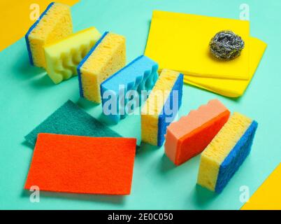 Home and bathroom cleaning kit on blue background. Sponges, abrasives. Stock Photo