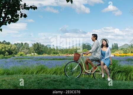 Young couples in the suburbs to ride a bicycle Stock Photo
