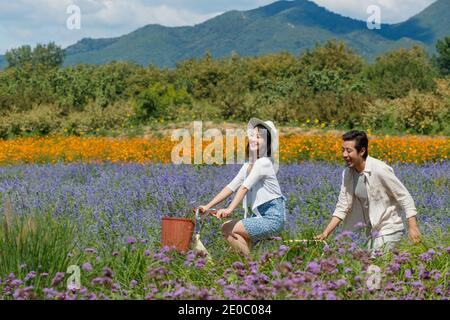 Young couples in the suburbs to ride a bicycle Stock Photo