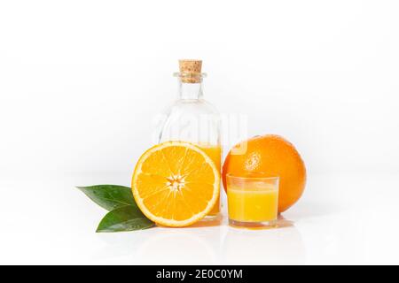 Orange and orange slice with orange juice and orange leaf isolated on white background. Stock Photo