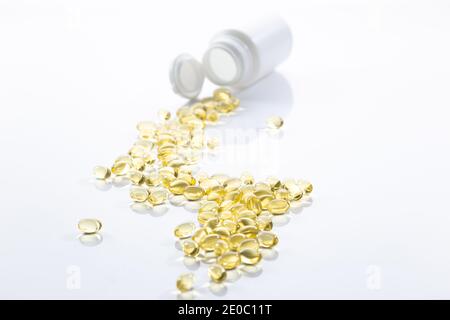 Spilled evening primrose oil capsules isolated on white background Stock Photo