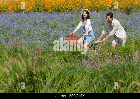 Young couples in the suburbs to ride a bicycle Stock Photo