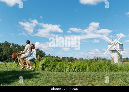 Young couples in the suburbs to ride a bicycle Stock Photo