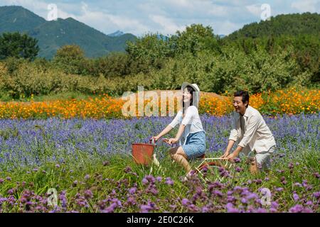 Young couples in the suburbs to ride a bicycle Stock Photo
