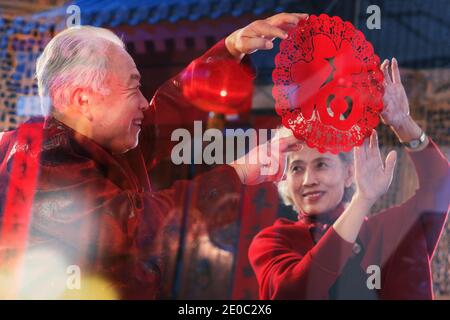 The Chinese elderly couple paste paper-cut Stock Photo