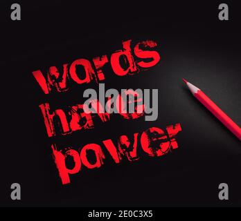 The phrase Words Have Power written in yellow pencil on black paper. Copywriting storytelling marketing business concept. Stock Photo