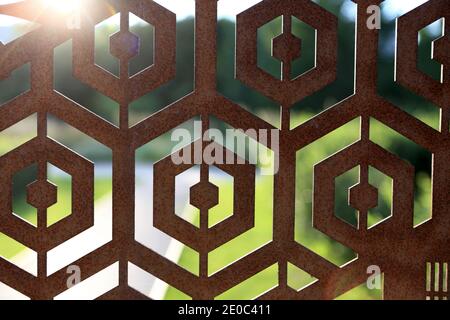 Details of rusty iron fence in summer park Stock Photo