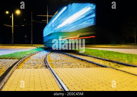 View to night city with motion tram. Stock Photo