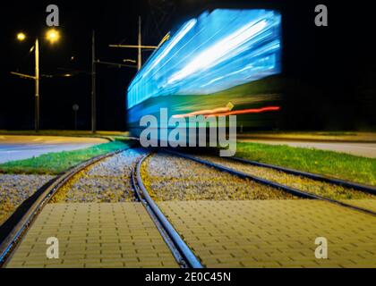 View to night city with motion tram. Stock Photo